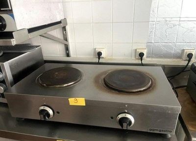 a stove top with two burners on it in a kitchen