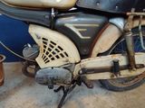 an old motorcycle that is parked in a garage