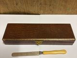 two knives and a box on a table