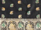 a close up of a black and gold sari with elephants on it