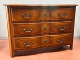 a wooden dresser with many drawers on top of it