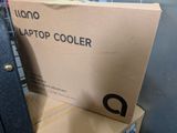 a box of laptop cooler sitting on top of a stack of boxes