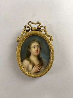 portrait of a young woman in a gold frame with a crown