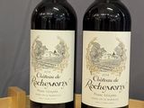 deux bouteilles de vin rouge posées sur une table en bois