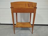 a small wooden table with a shelf on it
