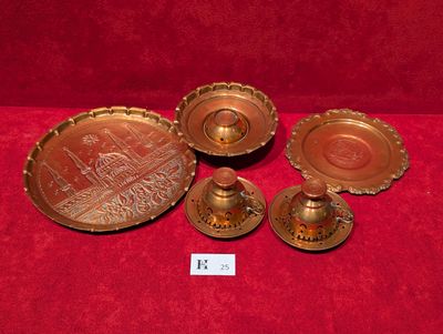 three brass candlesticks and a tray with a picture on it