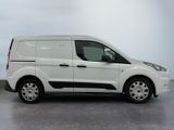 the white van is parked on the concrete floor in the room