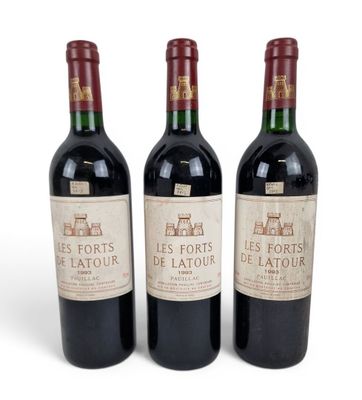 three bottles of red wine sitting next to each other on a white surface