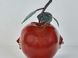 a red apple with a green leaf on it