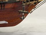 a model of a ship on display on a white surface