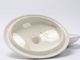 a white bowl with a lid on a white surface