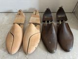 three pairs of wooden shoes are lined up on the floor