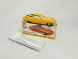 an orange toy car sitting on top of a white table