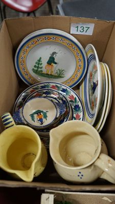 a cardboard box full of dishes and cups on a table