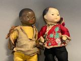 two dolls of a boy and a girl sitting next to each other