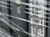 many plastic wrapped up items on the side of a building