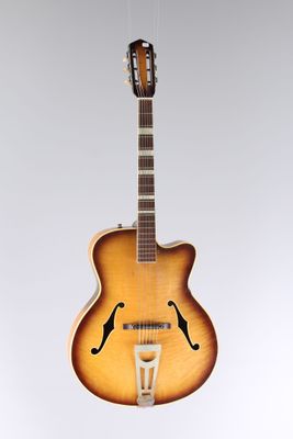 a close up of a guitar hanging from a string