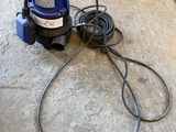 an image of a blue pressurer on a concrete floor