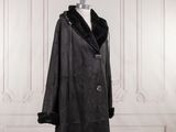 black leather coat with fur collar and cuffs on mannequin stand