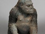 une petite statue représentant un gorille assis par terre