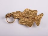 an image of a close up of a gold ring with a fish on it