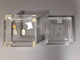 two small glass boxes with a picture of a man and a woman on them