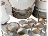 many different types of dishes and cups on the table