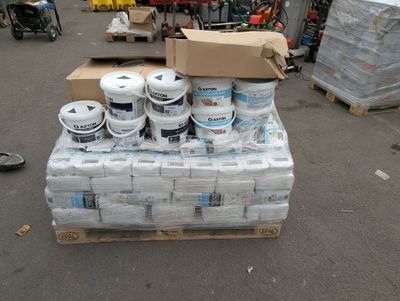 boxes of toilet paper are stacked on a pallet in a parking lot