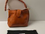 an image of a brown purse and a black bag on a table