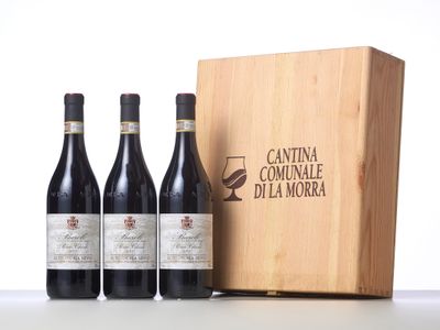 three bottles of wine in front of a wooden box