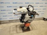 a close up of a motorcycle engine on a stand in front of a wall
