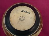 a brown and black vase with writing on it