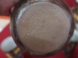 a close up of a person ' s hand holding a cup