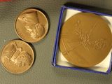 a gold medal with a picture of a man on it