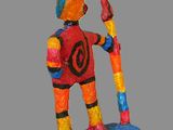 brightly colored figurine of a man holding a paintbrush and a paintbrush