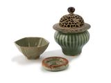 a small bowl and a small bowl with a lid on a white surface