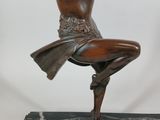statue of a woman holding a sword on a marble base