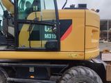 a picture of a yellow construction vehicle parked in a lot
