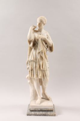 a white marble statue of a woman holding a baby