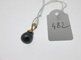 a tag with a black pearl attached to it