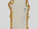 an image of a mirror with a gold frame sitting on a table