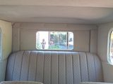 an image of the inside of a car with a couch and two chairs