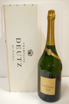 the bottle of champagne is next to the box of the wine