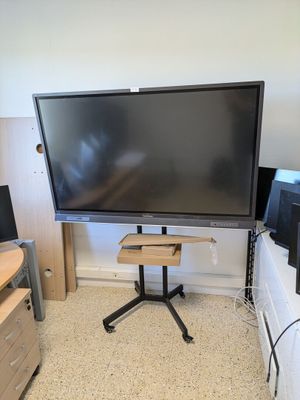 a flat screen tv sitting on a stand in the corner of a room