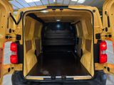 a yellow van with its doors open in a building