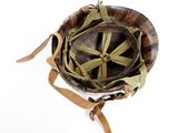 an old military helmet with a leather strap on a white background