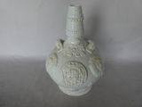 a white vase that is sitting on a table