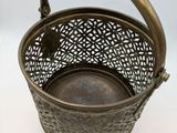 an antique brass basket with handle and handle