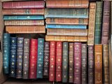 a box full of old books sitting on a table
