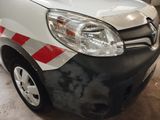 a white van with red and white stripes parked in a garage